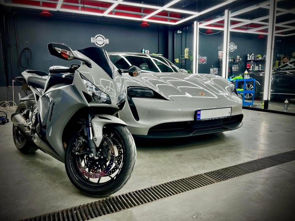 Premium motorcycle and Porsche being detailed at Auto Formula studio